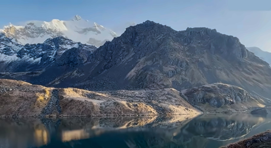 Meme Pokhari lake with mountain background.