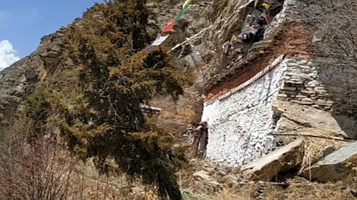 Praken Gompa building with prayer flags.