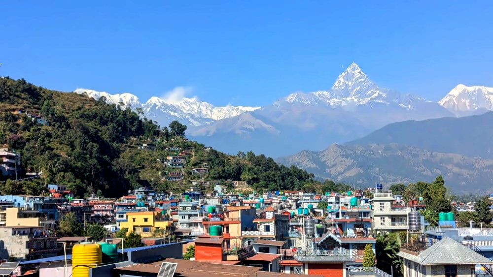 Blick über Pokhara mit Himalaya-Gipfeln im Hintergrund.