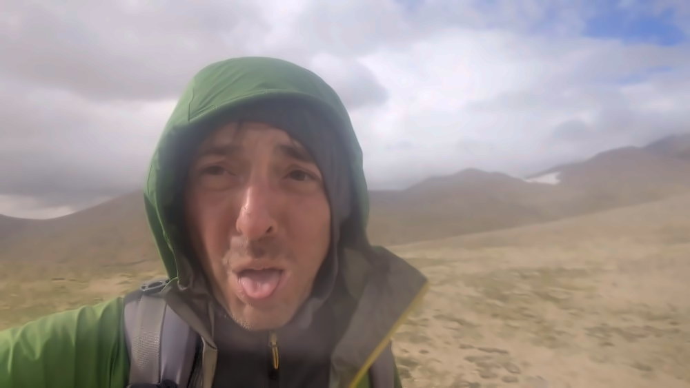 Großaufnahme eines erschöpften Trekker auf einem 5.000 Meter hohen Hochpass in der Wüste von Ladakh.